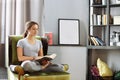 Woman reading book at home in the living room Royalty Free Stock Photo