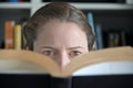 Woman reading a book in library