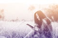 Woman reading book in meadow Royalty Free Stock Photo