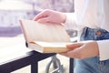 Woman reading book outdoors on sunny day Royalty Free Stock Photo