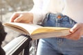 Woman reading book outdoors on sunny day Royalty Free Stock Photo