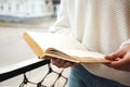 Woman reading book outdoors on sunny day Royalty Free Stock Photo