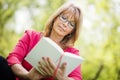 Woman reading a book in the park