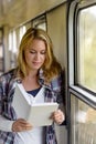 Woman reading book on train hall vacation Royalty Free Stock Photo