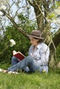 Woman reading a book under a tree Royalty Free Stock Photo