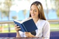 Woman reading a book during vacations on the beach Royalty Free Stock Photo