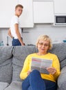 Woman reading booklet on sofa Royalty Free Stock Photo