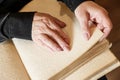 Woman reading braille text on old book Royalty Free Stock Photo