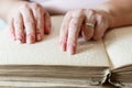 Woman reading braille text on old book Royalty Free Stock Photo