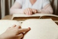 Woman reading braille text on old book Royalty Free Stock Photo