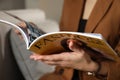 Woman reading fashion magazine on sofa at home, closeup Royalty Free Stock Photo