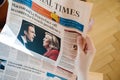 Woman reading Financial Times with Emmanuel Macron and Marine L