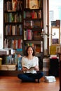 Woman, reading and floor in bookstore, portrait or relax with development for knowledge, information and literature Royalty Free Stock Photo