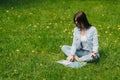 Woman reading on grass in park Royalty Free Stock Photo