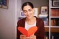 Woman, reading and heart letter in home for valentines day, memory and happy for celebration with sign. Girl, person and Royalty Free Stock Photo