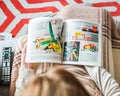 Woman reading IKEA catalog furnishing house kids furniture