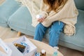 woman reading ingredient and hold bottle of drug on sofa at home Royalty Free Stock Photo