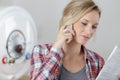 woman reading instructions for appliance while phoning support line Royalty Free Stock Photo