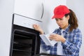 Woman reading instructions for new oven