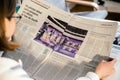 Woman Reading Le Monde newspaper with French presidential debate