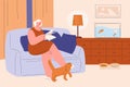 Woman reading in living room. Grandmother sitting at sofa read newspaper and big red cat rubs against legs. Cozy evening Royalty Free Stock Photo