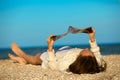 Woman reading magazine on beach Royalty Free Stock Photo