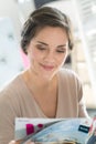 woman reading magazine in cafe Royalty Free Stock Photo