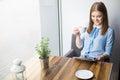 Woman reading magazine and drinking cappuccino Royalty Free Stock Photo