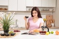 Woman Reading Magazine and drinking tea In Kitchen Royalty Free Stock Photo