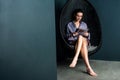 Woman reading magazine, sitting on swinging chair