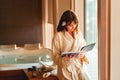 Woman reading magazine while waiting for massage at spa center Royalty Free Stock Photo