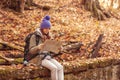 Woman reading a map while hiking through the forest Royalty Free Stock Photo