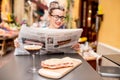 Woman reading newspaper at the cafe outdoors Royalty Free Stock Photo