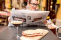 Woman reading newspaper at the cafe outdoors Royalty Free Stock Photo