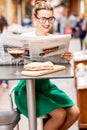 Woman reading newspaper at the cafe outdoors Royalty Free Stock Photo