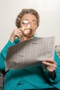 Woman reading newspaper with magnifying glass Royalty Free Stock Photo