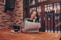 Woman reading a newspaper and talking on mobile phone Royalty Free Stock Photo