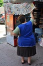 Woman reading newspapers