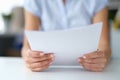 Woman reading notice of mortgage payments closeup