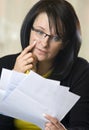 Woman reading pile of bills Royalty Free Stock Photo