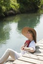 Woman reading by the river