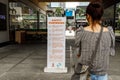 Woman reading safety signs at Bonifacio High street, Makati city, Metro Manila , Philippines, Dec 8, 2020 Royalty Free Stock Photo