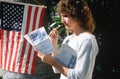 Woman reading sample voting ballot