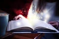 Woman reading shiny magic book, closeup Royalty Free Stock Photo