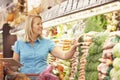 Woman Reading Shopping List From Digital Tablet In Supermarket Royalty Free Stock Photo