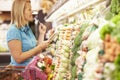 Woman Reading Shopping List In Supermarket Royalty Free Stock Photo