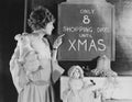 Woman reading sign with number of shopping days until Christmas Royalty Free Stock Photo