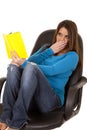 Woman reading surprised in chair