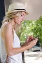 woman reading text message while waiting bus Royalty Free Stock Photo