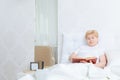 Woman reads a book in bed Royalty Free Stock Photo